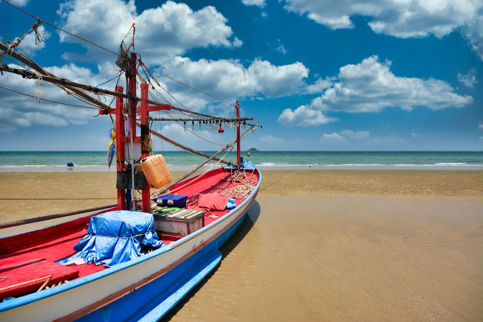 A colourful Thai fishing boat on the sand at Hua Hin