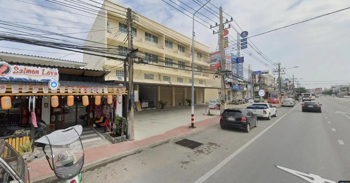 Salmon Love restaurant and the cream four-storey building next to it on Phetkasem Road